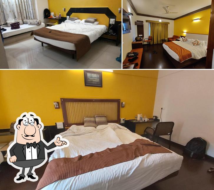 Take a seat at one of the tables at Hotel Vrishali Executive