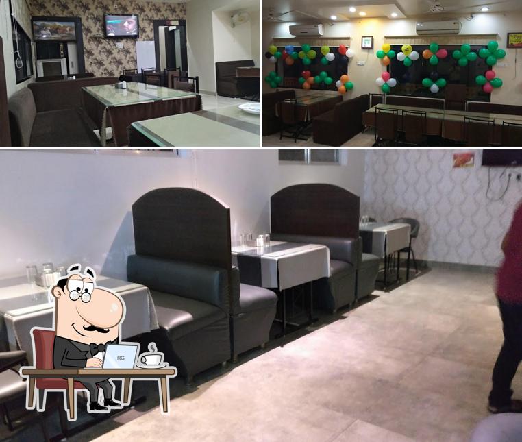 Take a seat at one of the tables at TADKAA FAMILY RESTAURANT