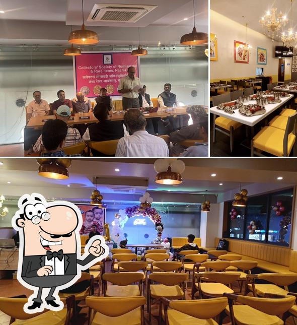 Take a seat at one of the tables at Manbhavan Premium Thali Restaurant