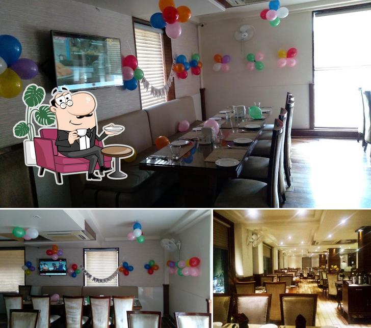 Take a seat at one of the tables at Pehli Manzil Restaurant