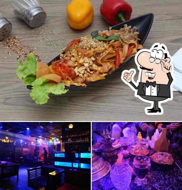 Take a look at the photo showing interior and food at The Jugnu Cafe