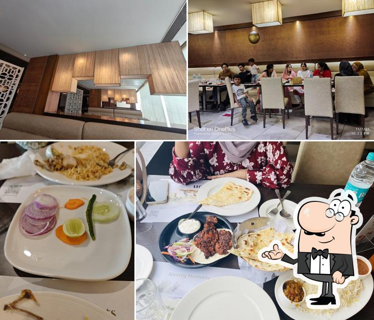 Take a seat at one of the tables at Zaitoon Restaurant , JP Nagar