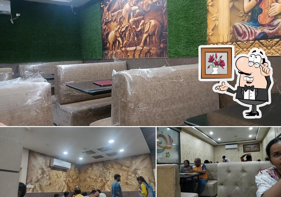Take a seat at one of the tables at Shree Santosh Family Dhaba (Pure Veg Restaurant)
