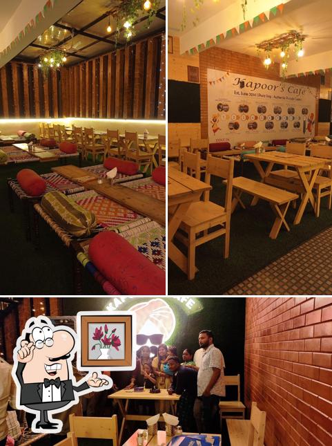 Take a seat at one of the tables at Kapoor's Cafe - KR Puram