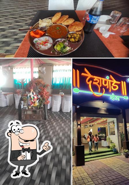 The picture of interior and beverage at Deshpande veg saswad