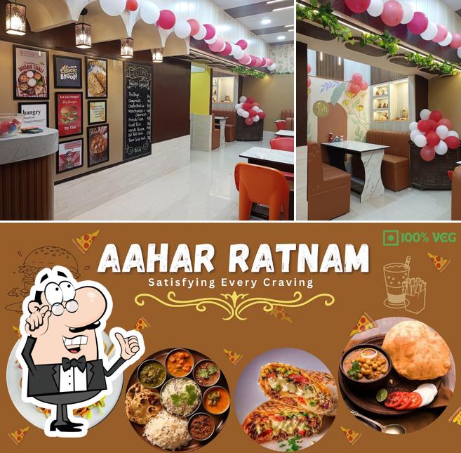 The photo of interior and food at Aahar Ratnam