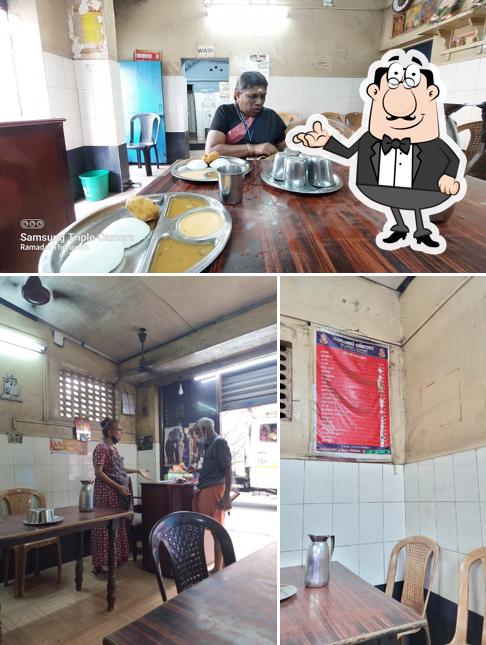 Take a seat at one of the tables at Ganapathy Vilas Restaurant Thrissur (Pure Veg)
