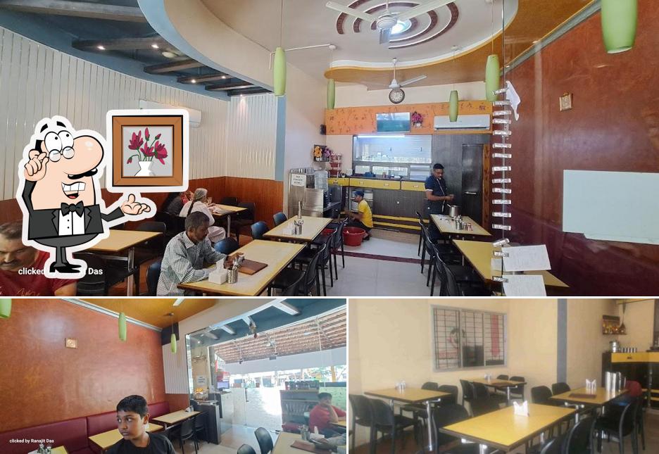 Take a seat at one of the tables at Hotel Deshi Tadka