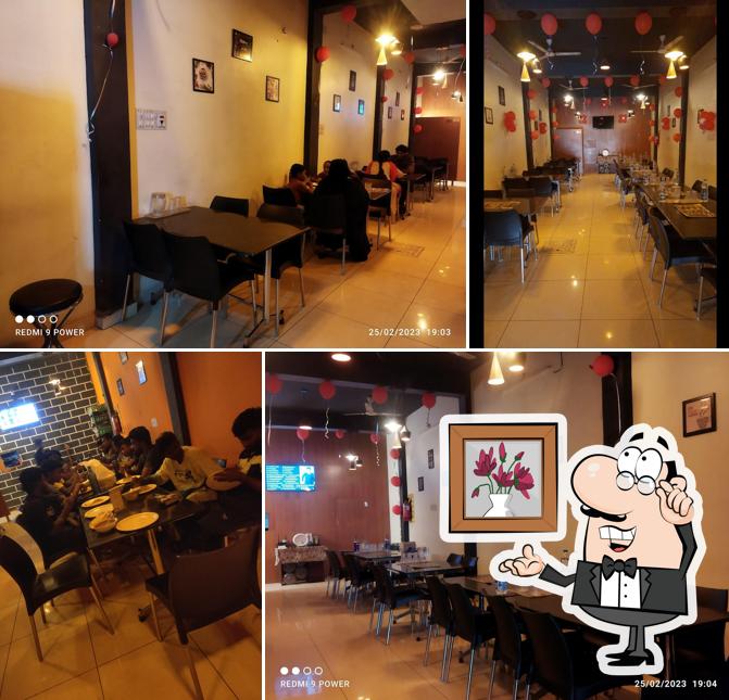 Take a seat at one of the tables at KCC Family Restaurant - Gudiyattam