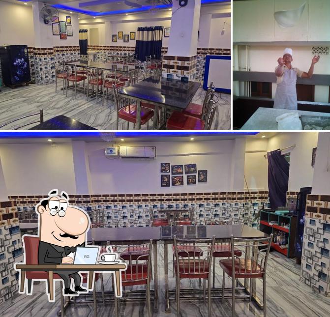 Take a seat at one of the tables at Pushpa hotel and a/c family restaurant