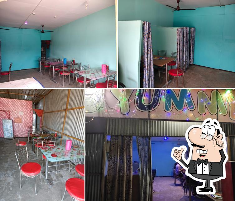 Take a seat at one of the tables at Yummy Restaurant Baniyapur