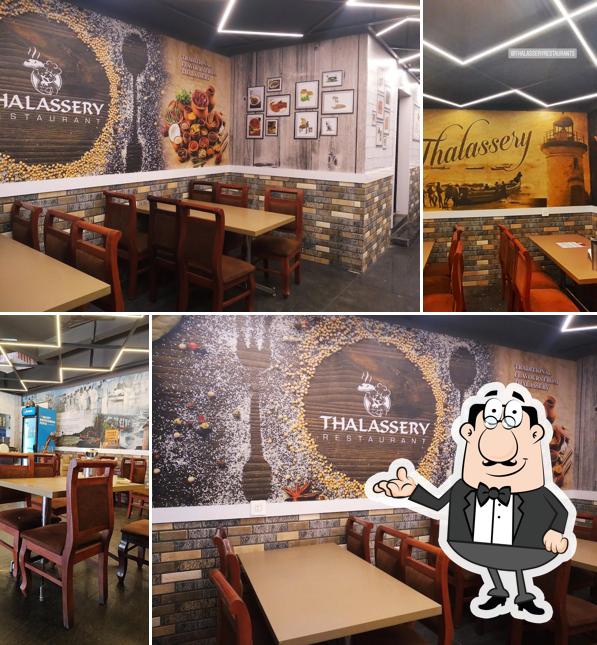 Take a seat at one of the tables at Thalassery restaurant