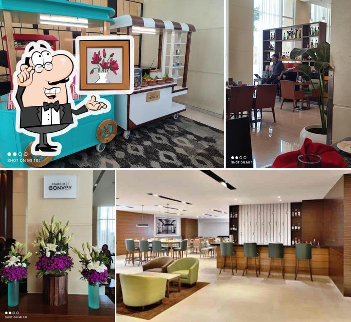 Take a seat at one of the tables at Kava, Fairfield by Marriott Outer Ring Road