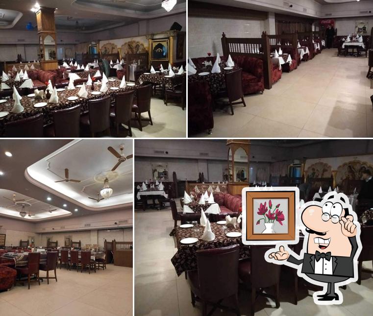 Take a seat at one of the tables at Zannat Restaurant