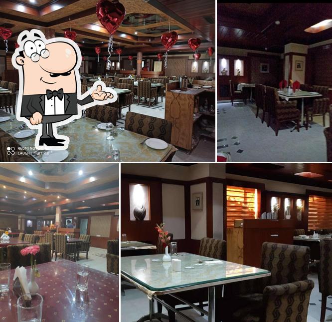 Take a seat at one of the tables at Grand Darbar Restaurant