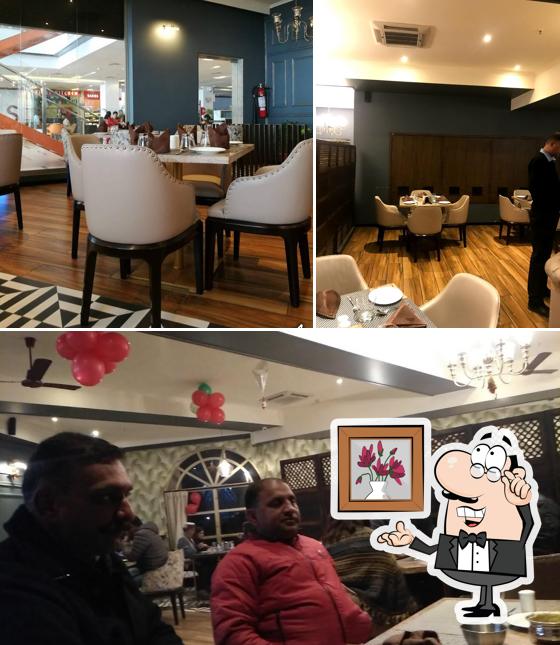 Take a seat at one of the tables at Moti Mahal Delux, Maximus mall