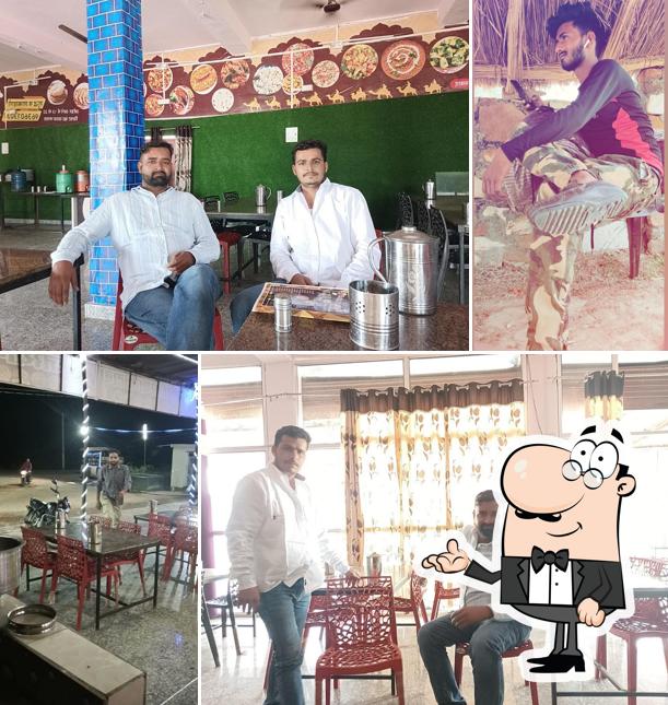 Take a seat at one of the tables at RAJASTHANI DHABA
