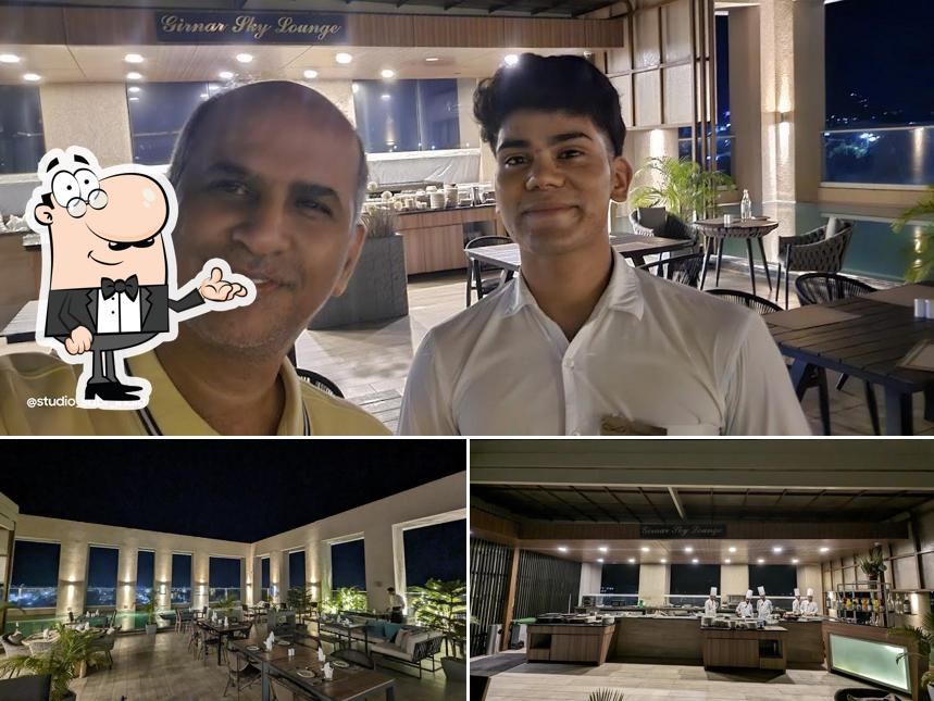 Take a seat at one of the tables at Girnar Sky Lounge