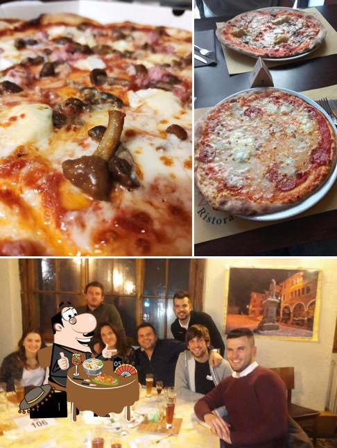 Questa è la immagine che presenta la cibo e tavolo da pranzo di Zeus Pizza