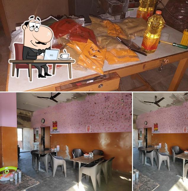 Take a seat at one of the tables at Maa Karni Kripa Hotel