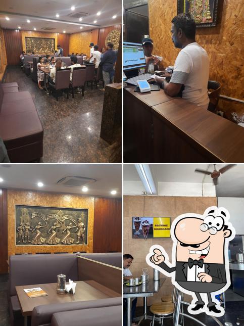 Take a seat at one of the tables at Nandavanam Veg Restaurant