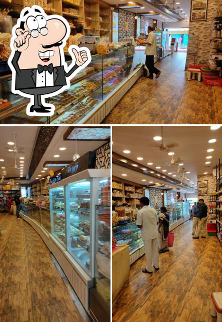 Take a seat at one of the tables at Malathi Sweet and Snacks