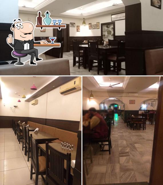 Take a seat at one of the tables at RASRAJ (Veg.)