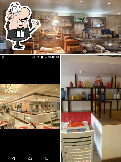 Take a seat at one of the tables at Zest Café & Kitchen - Holiday Inn
