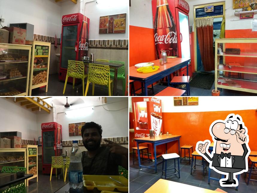 Take a seat at one of the tables at Ganesh Shree Sweets and Snacks