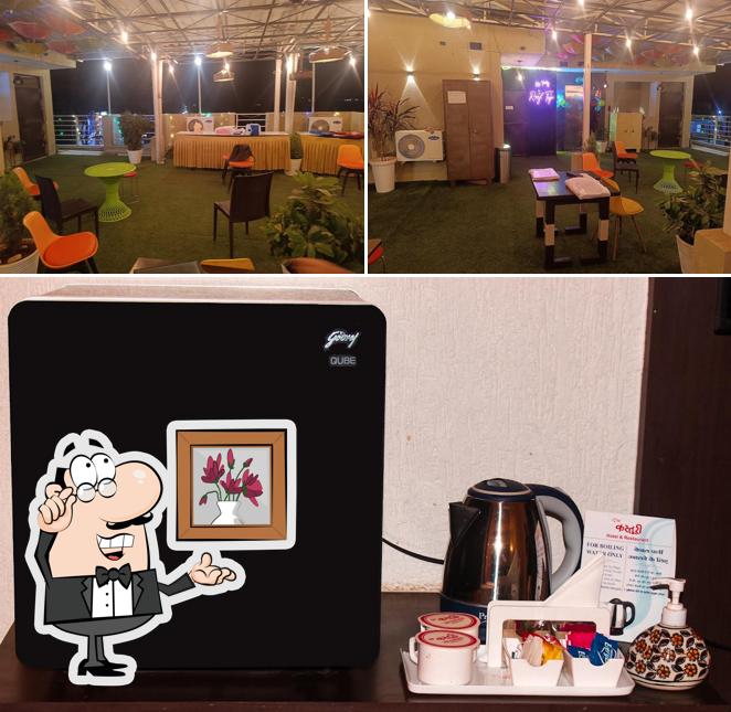 Take a seat at one of the tables at The Kasturi Hotel & Restaurant