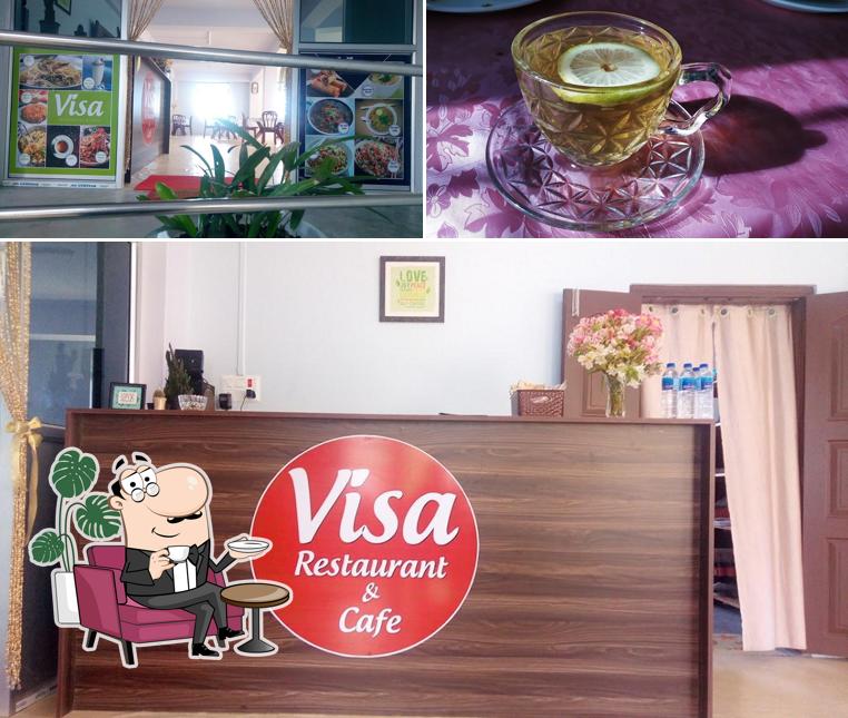 The photo of interior and beverage at Visa Restaurant And Cafe