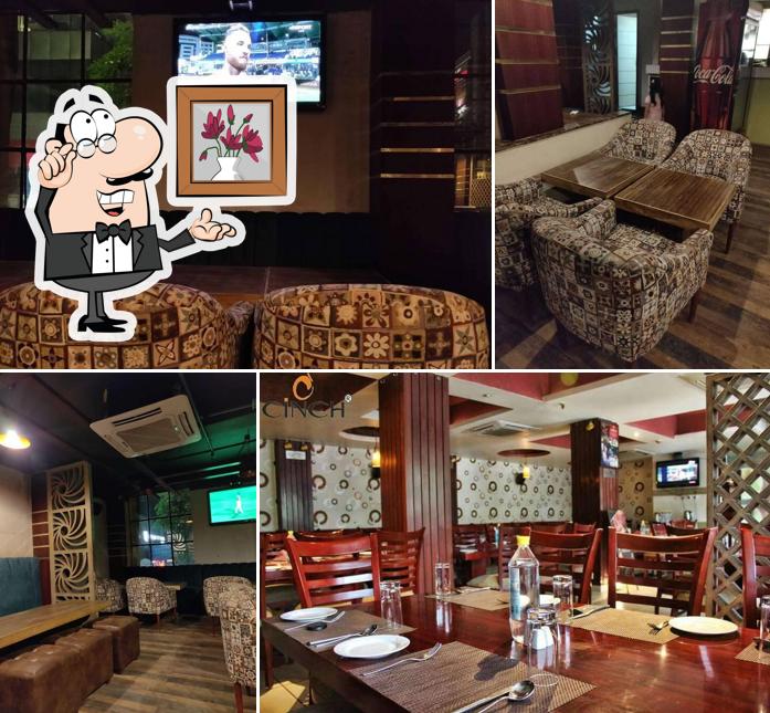 Take a seat at one of the tables at Cinch Restaurant & Lounge Bar