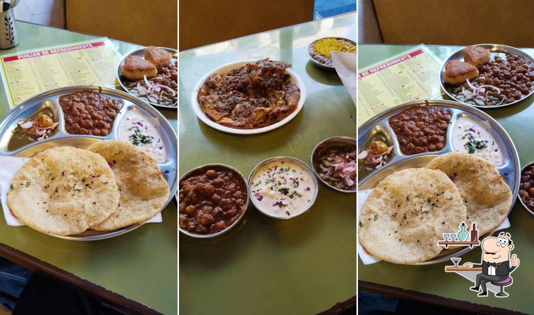Take a seat at one of the tables at PUNJAB SE REFRESHMENTS