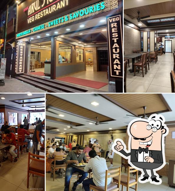 Take a seat at one of the tables at Sree Arul Jyothi (Veg Restaurant)