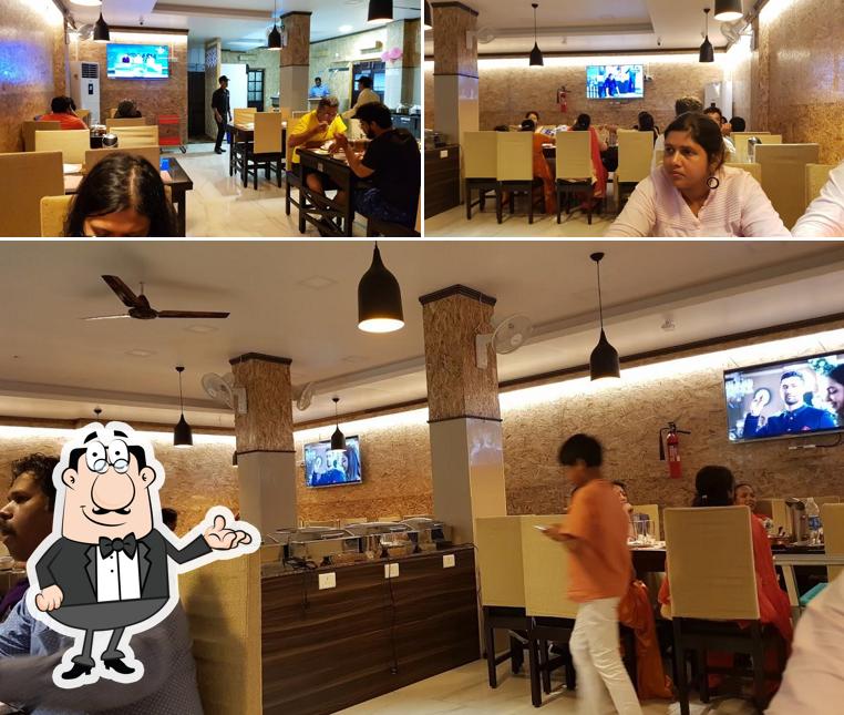 Take a seat at one of the tables at Deliciaa Restaurant