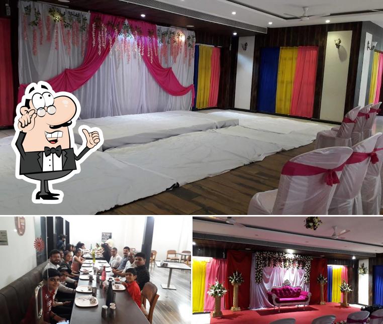 Take a seat at one of the tables at Hotel Shree Ganga