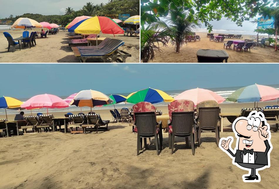 Take a seat at one of the tables at Mango Tree Bar & Restaurant