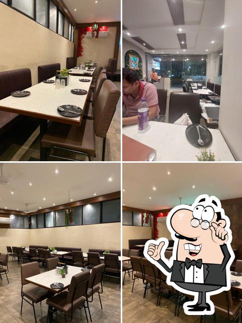 Take a seat at one of the tables at Shreeleela Restaurant Bengali Square