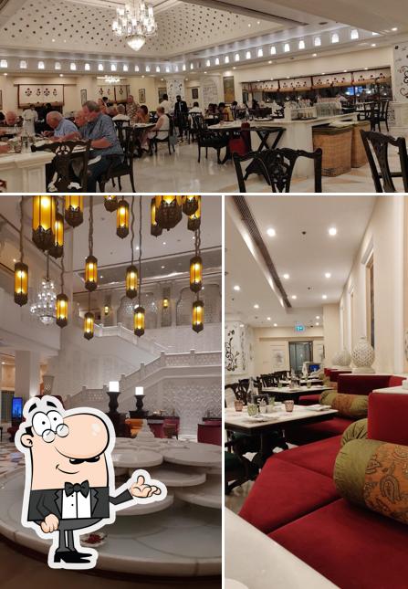 Take a seat at one of the tables at Jal Mahal Restaurant