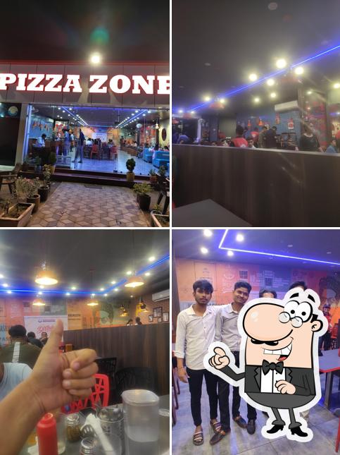 Take a seat at one of the tables at Pizza Zone