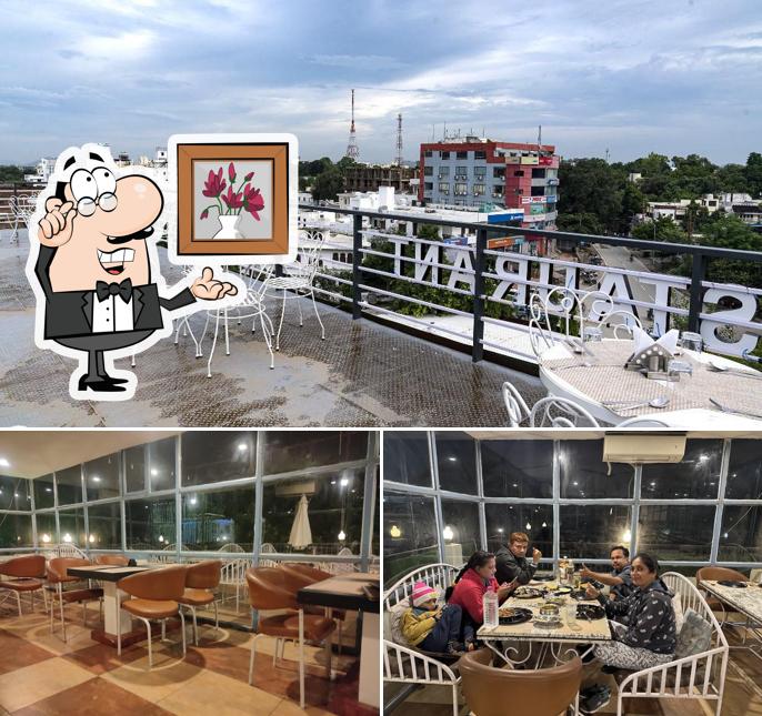 Take a seat at one of the tables at Udaipur View Restaurant