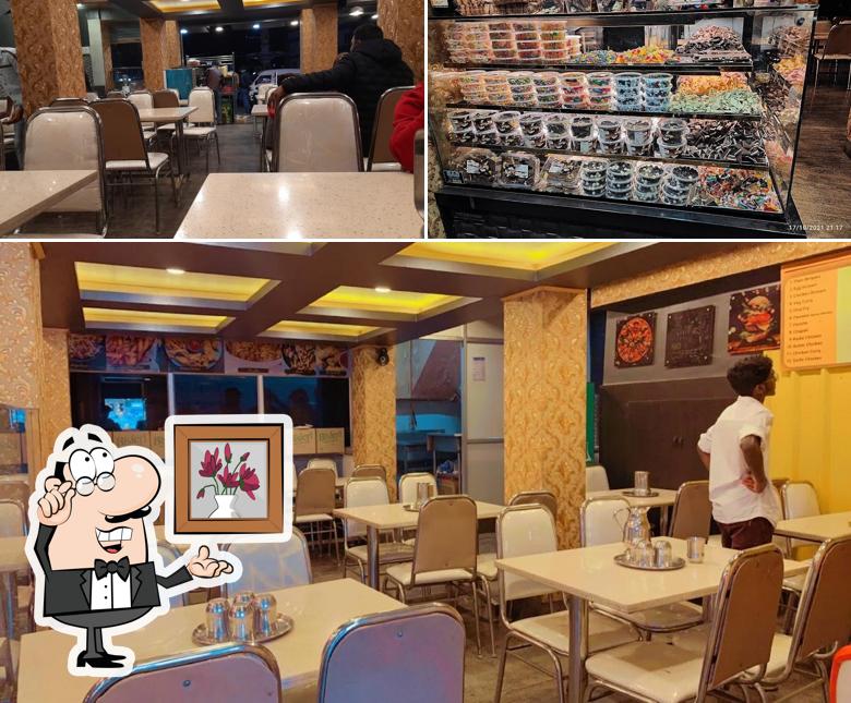Take a seat at one of the tables at Al-Madina(The Biriyani House)& Ooty bakery