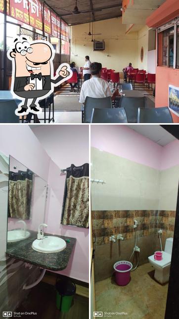 Take a seat at one of the tables at HOTEL VIJAYASHREE LODGINING & BOARDING