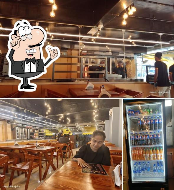 Take a seat at one of the tables at Al Taza - Kollam