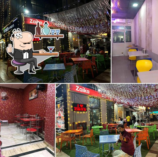 Take a seat at one of the tables at Zaika Restaurant Greater Noida