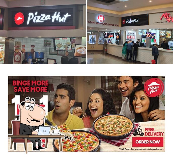 Take a seat at one of the tables at Pizza Hut Pavilion Mall, Ludhiana