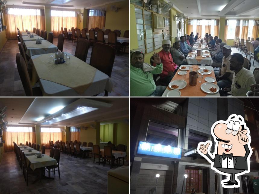 Take a seat at one of the tables at Swayamprabha Restaurant