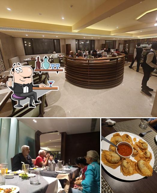 The photo of interior and food at Pavilion Restaurant