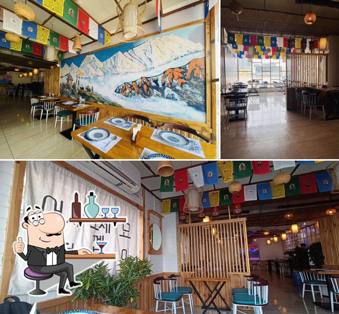 Take a seat at one of the tables at TTEOKBOKKI ( korean - pan asian- himalayan )