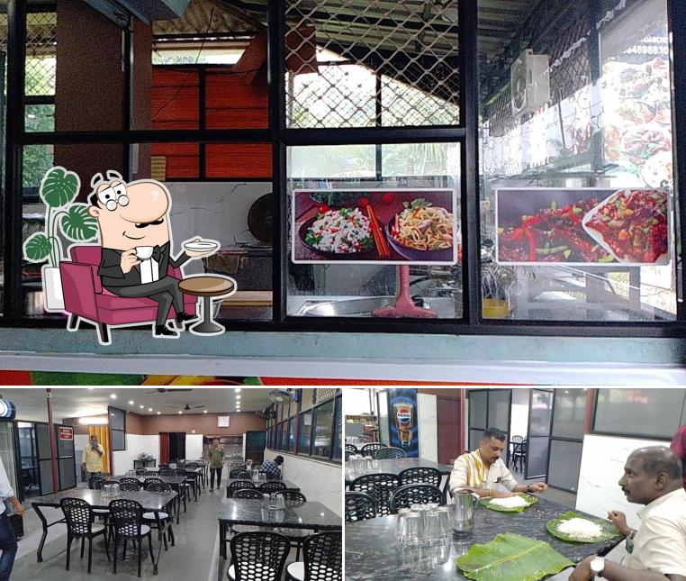 Take a seat at one of the tables at Kunjatta Hotel. കുഞ്ഞാറ്റ ഹോട്ടൽ
